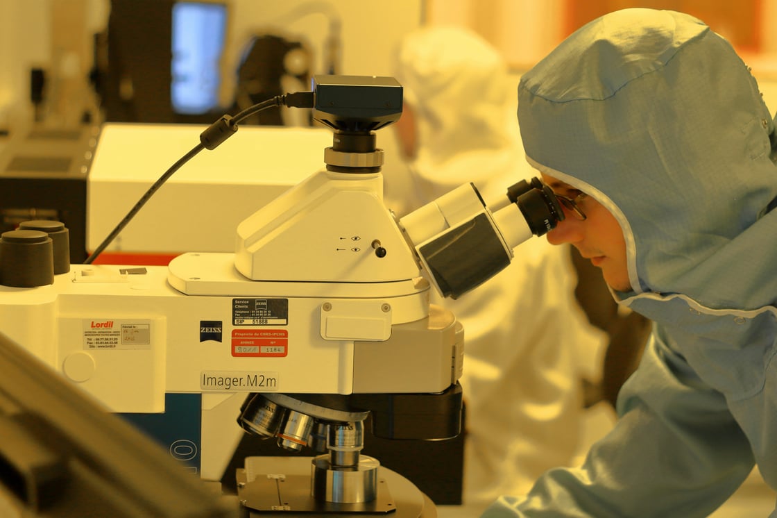 Researcher using a microscope